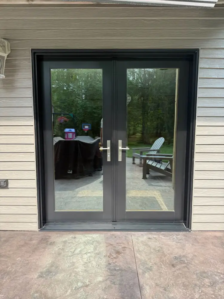 Black-framed French patio doors with brushed-nickel handles